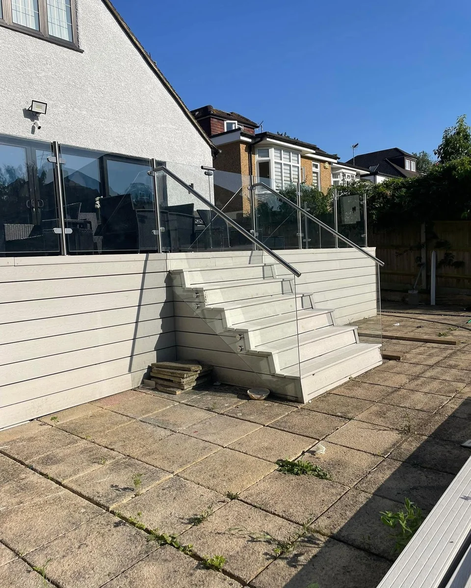 Frameless outdoor glass balustrade on a sunny raised patio, Sevenoaks property
